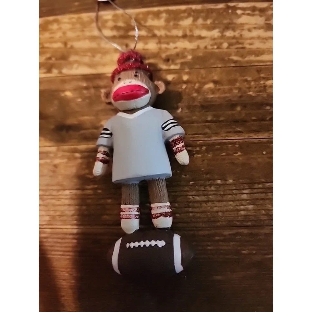 Christmas ornament sock monkey wearing Gray jersey standing on Football
